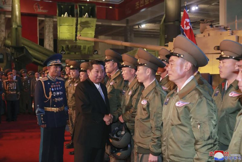 In this photo provided by the North Korean government, North Korean leader Kim Jong Un, second from left, meets fighter pilots who made the demonstration flight at the opening of an exhibition of weapons systems in Pyongyang, North Korea on October 11, 2021. Kim reviewed the rare exhibition and vowed to build an “invincible” military, as he accused the United States of creating regional tensions and lacking action to prove it has no hostile intent toward the North, state media reported Tuesday. Independent journalists were not given access to cover the event depicted in this image distributed by the North Korean government. The content of this image is as provided and cannot be independently verified. Korean language watermark on image as provided by source reads: "KCNA" which is the abbreviation for Korean Central News Agency. (AP Photo)